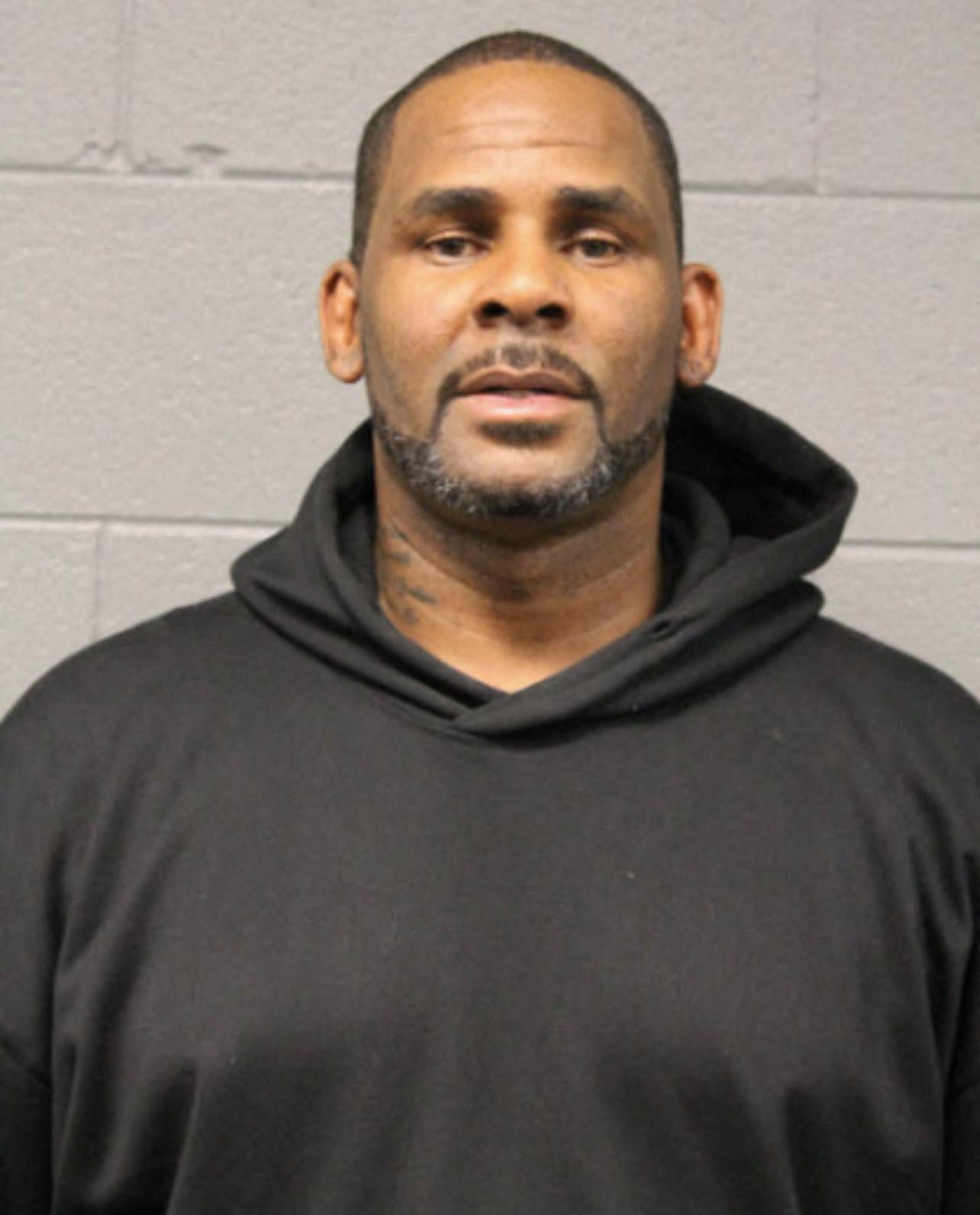 R. Kelly looks poker faced in mug shot after being booked of sex abuse charges